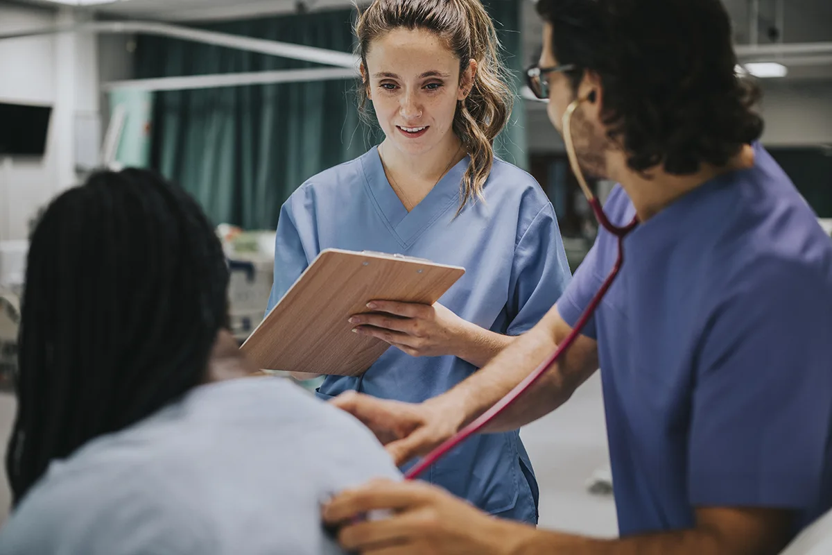 Medical students speaking to a patient